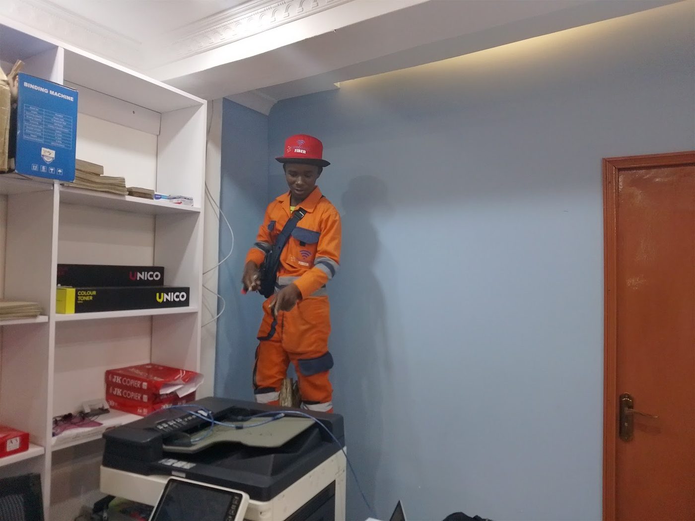 ModoTech fibre technician at the Membley office beside the photocopier