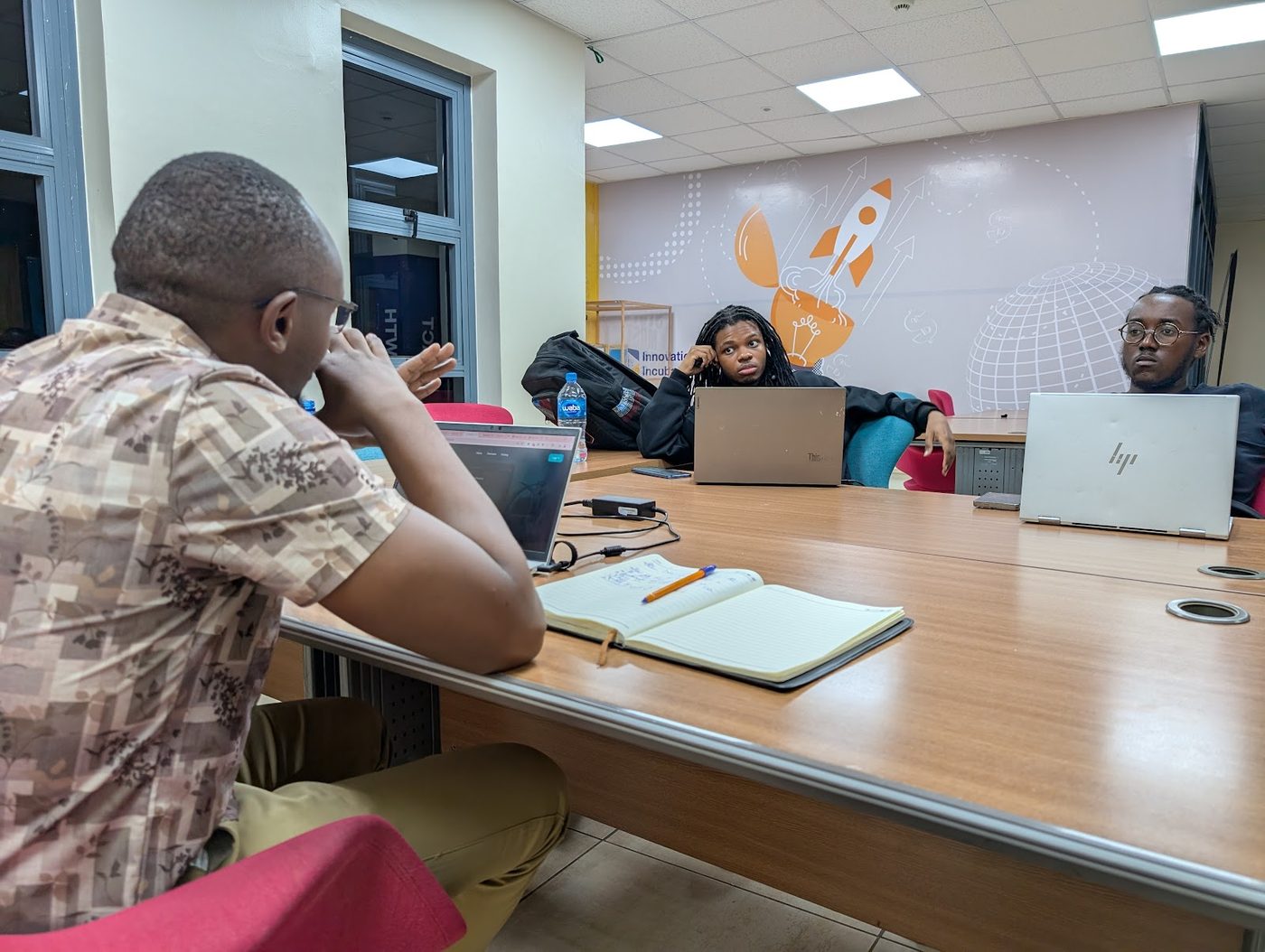 ModoTech software team in a planning session with laptops