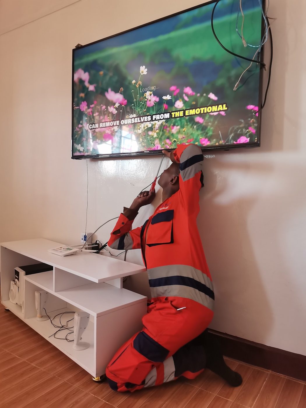 ModoTech technician cabling a wall-mounted television